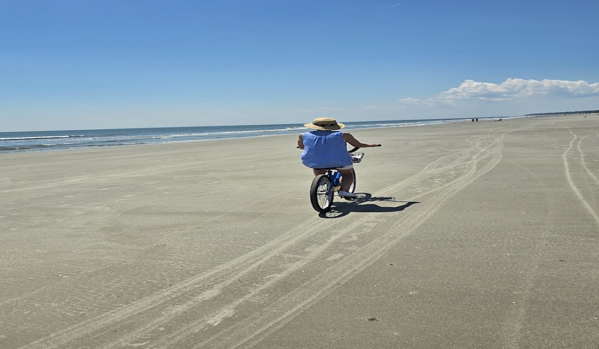 A woman biking on the beach